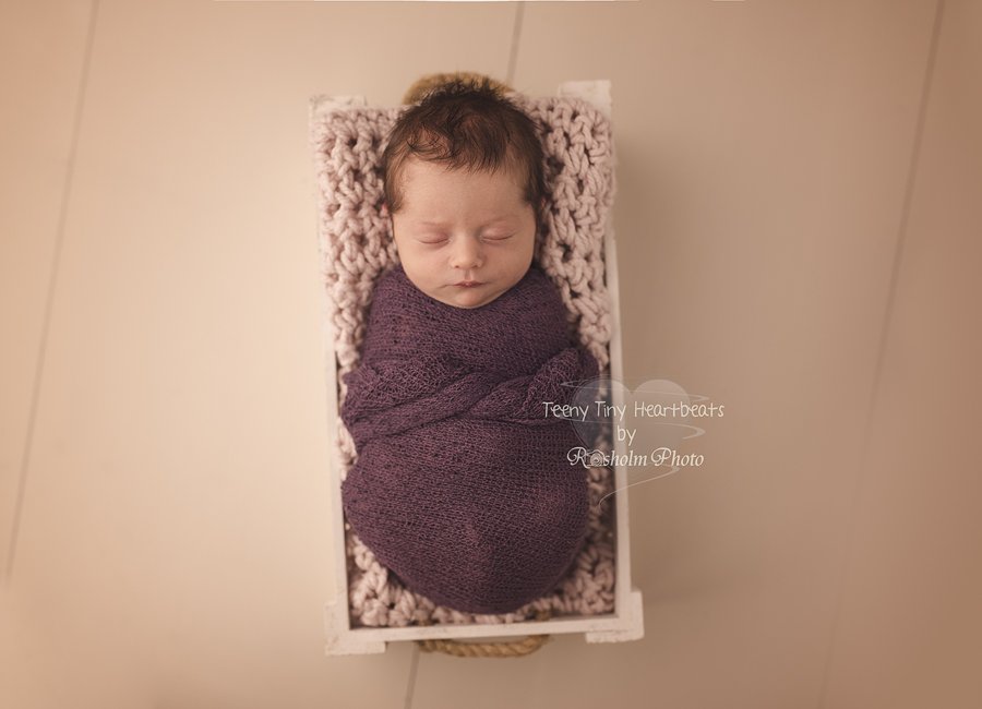 sovende baby foto pakket ind i lilla wrap i hvid kasse